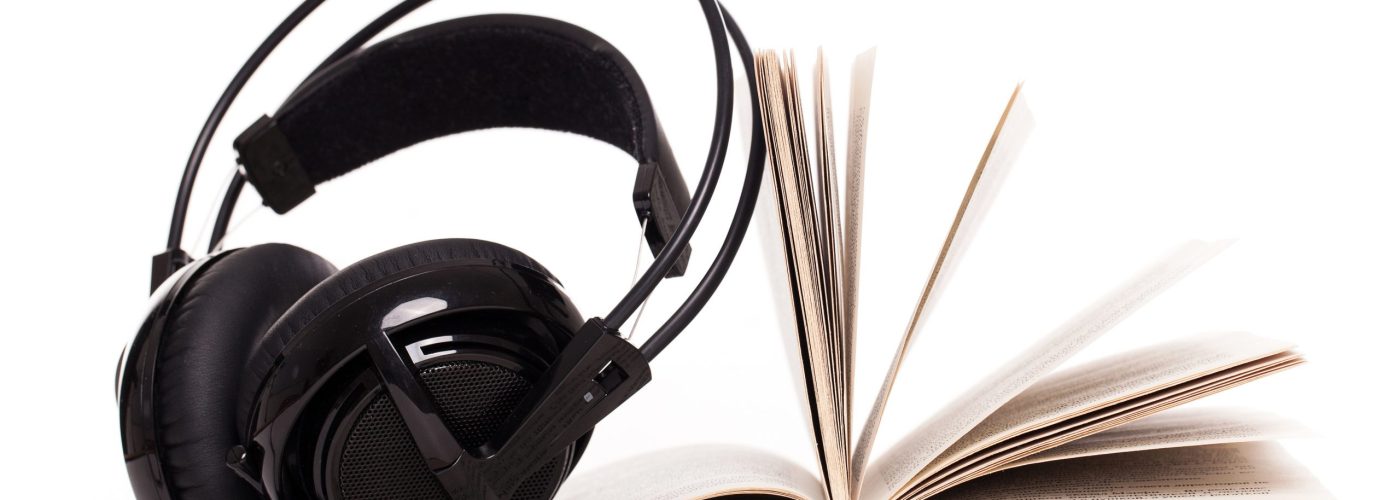 Big headphones and book on a white background