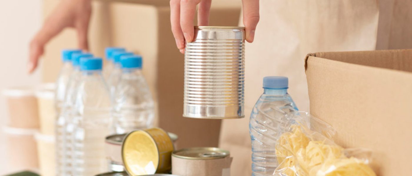 volunteers-putting-canned-food-for-donation-in-box