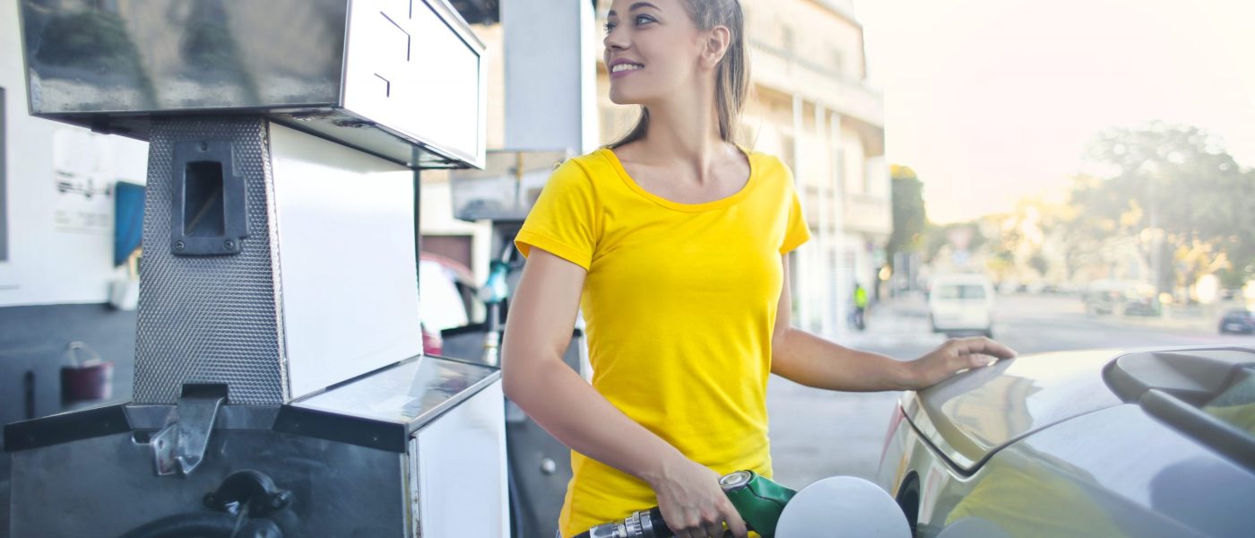woman-in-yellow-shirt-while-filling-up-her-car-with-gasoline-3812750